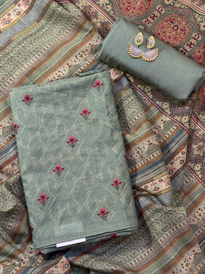A refined munga silk suit in a graceful green tone, complemented by a stunning printed dupatta.
