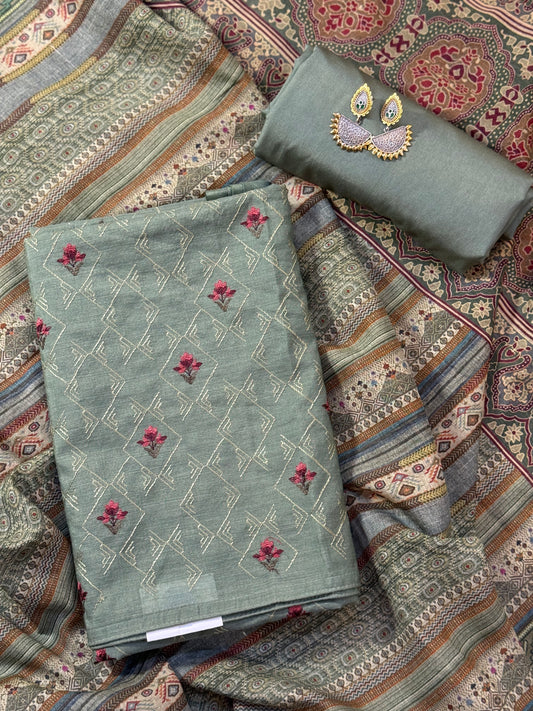 A refined munga silk suit in a graceful green tone, complemented by a stunning printed dupatta.